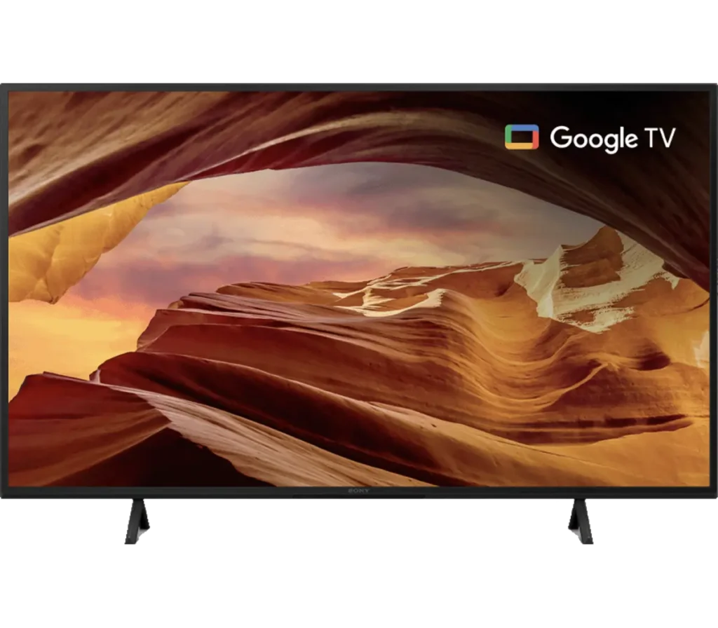A Sony TV displaying a scenic view of colorful rock formations and a sunset, featuring the Google TV interface at the top corner.